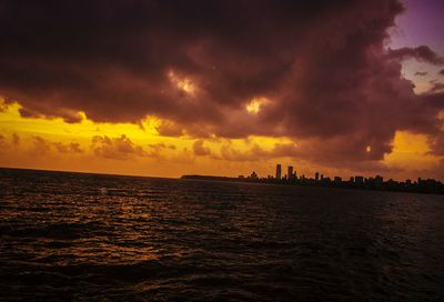 View of city at waterfront during sunset