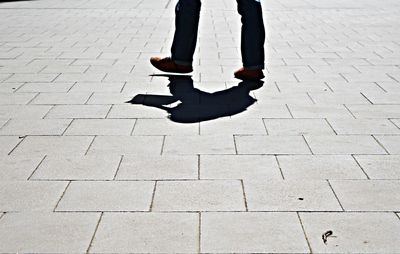 Low section of man walking on footpath