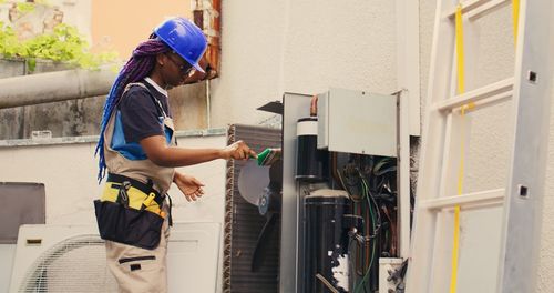 Side view of young woman working at home