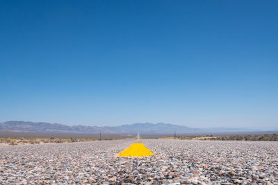 Scenic view of field against clear blue sky