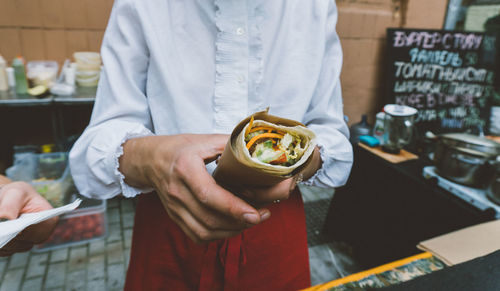 Midsection of man working at restaurant