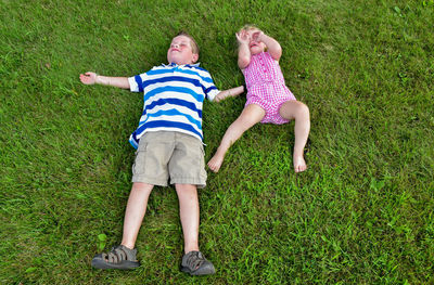 High angle view of children lying on grass