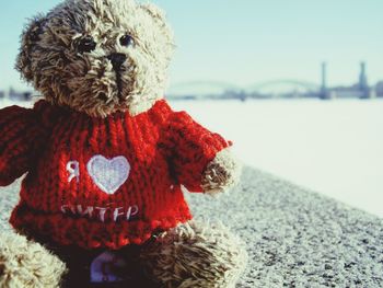 Close-up of red toy against sky during winter