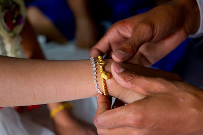 Close-up of couple holding hands