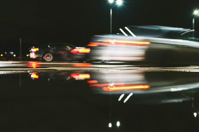 Blurred motion of vehicle on city street at night