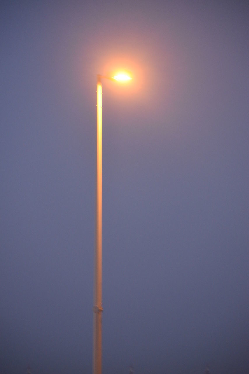 LOW ANGLE VIEW OF ILLUMINATED STREET LIGHT AGAINST ORANGE SKY