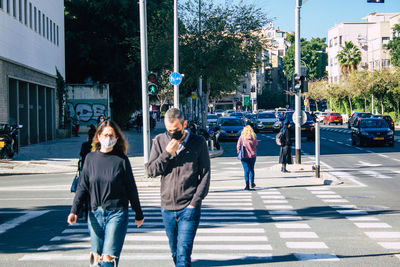 Full length of woman crossing road