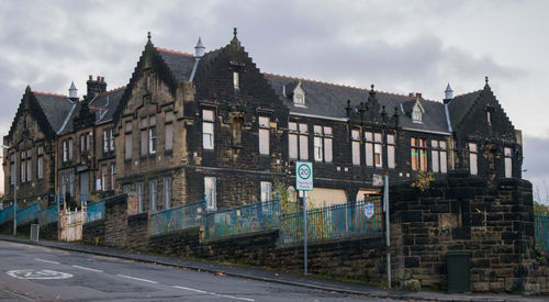 Buildings against cloudy sky