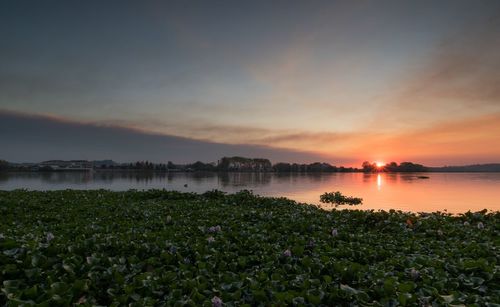 Scenic view of lake against sky during sunset