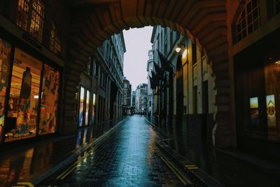 Empty street amidst buildings in city