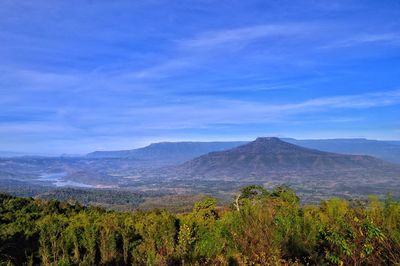 Scenic view of mountains against blue sky