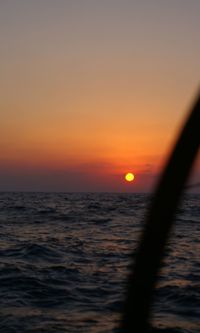 Scenic view of sea against orange sky