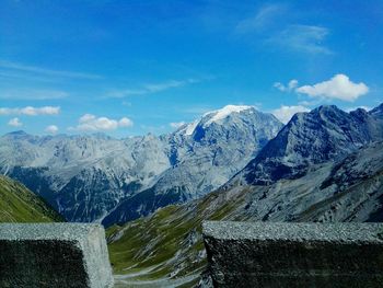 Scenic view of mountains against blue sky