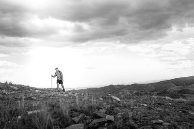 Man standing on field against sky