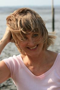 Portrait of smiling senior woman at beach