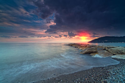 Scenic view of sea against sky at sunset