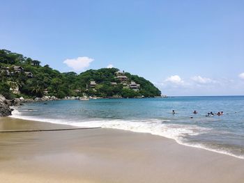 Scenic view of beach against blue sky