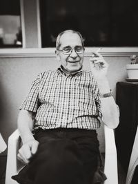 Portrait of man sitting at home