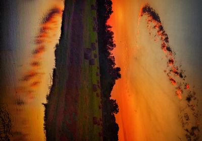 Scenic view of field against sky during sunset