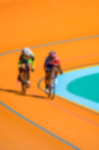 Blurred motion of people running against orange wall