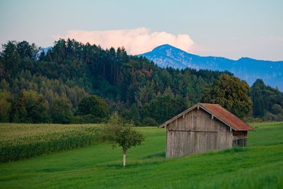 Built structure on field against mountain range