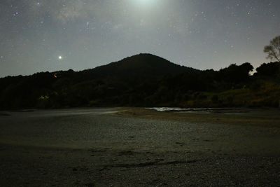 Scenic view of mountains against sky at night