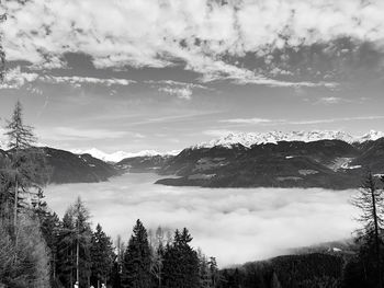 Scenic view of mountains against cloudy sky