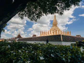 View of temple building against cloudy sky
