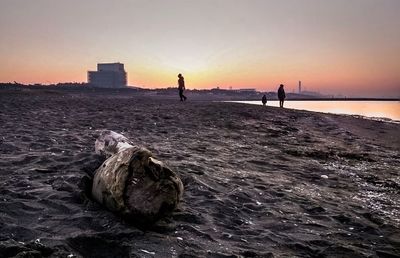 Scenic view of beach against clear sky during sunset