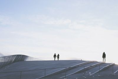 Men on road against sky