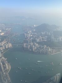 High angle view of buildings by sea against sky