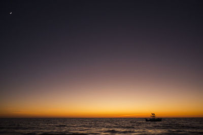 Scenic view of sea against clear sky during sunset