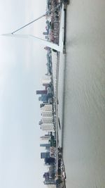 High angle view of buildings by sea against sky