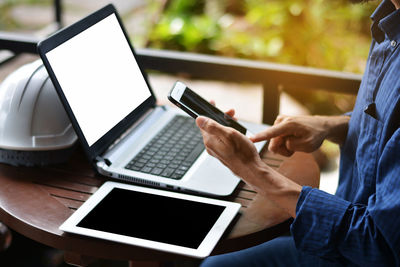 Low angle view of man using laptop on table