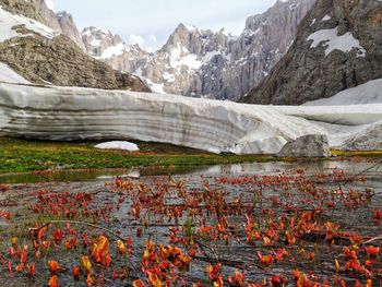 Scenic view of lake and mountains against sky