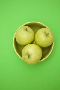 Directly above shot of apples on green background