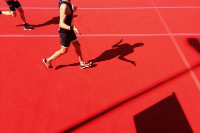 Low section of runner gesturing on running track