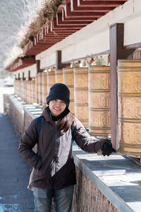 Portrait of young woman standing in snow