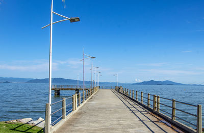 Pier on sea against sky