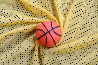 Directly above shot of basketball on patterned fabric