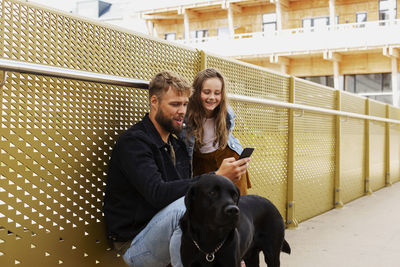 Father with daughter looking at cell phone