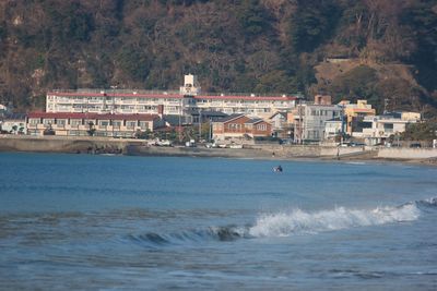 Scenic view of sea against buildings