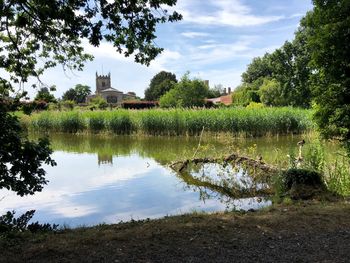 Scenic view of lake by building against sky
