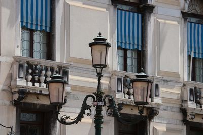 Low angle view of street light against building