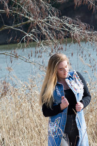 Young woman standing against plants in water