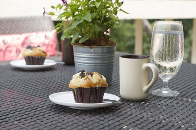 Close-up of ice cream and potted plant on table