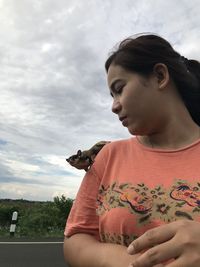 Mid adult man looking at camera against sky