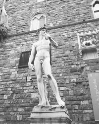 Low angle view of statue against building