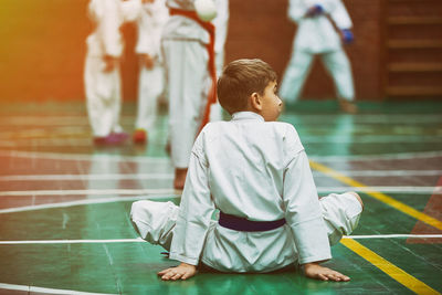 Rear view of boy looking at camera