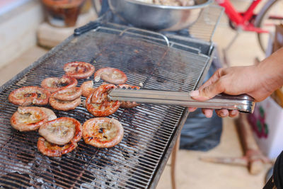 Man preparing food on barbecue grill